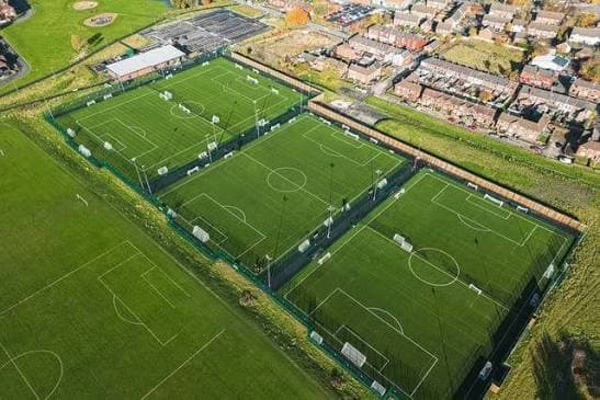 Aerial view of Cherrybrook FC’s turf pitches beside rows of houses in Wigan.