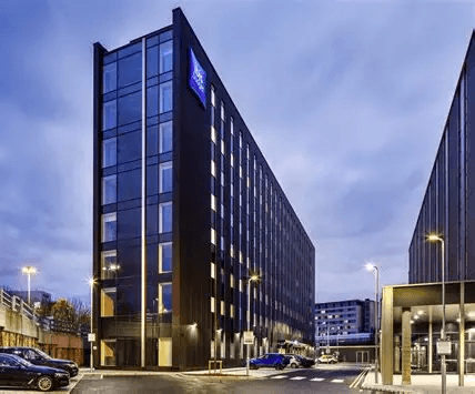 The ibis budget hotel at Manchester Airport in the evening.